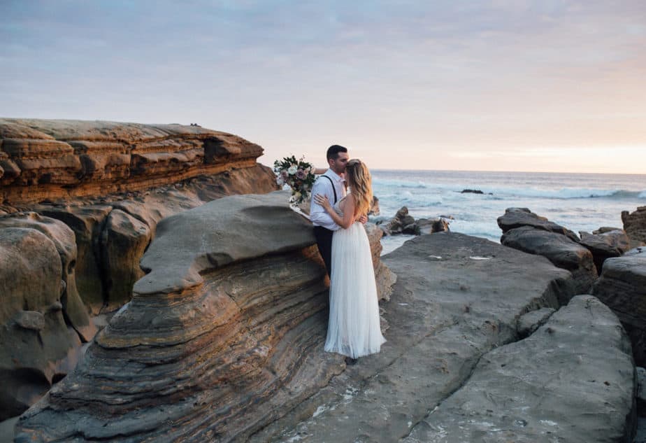 Sunset portrait of bride and groom during their beach elopement in San Diego, California. 