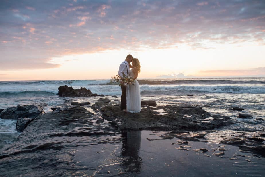 Sunset portrait of bride and groom during their beach elopement in San Diego, California. 