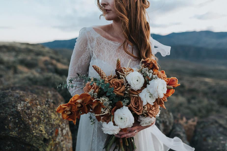 Bride poses with her wedding bouquet in Sedona, Arizona.