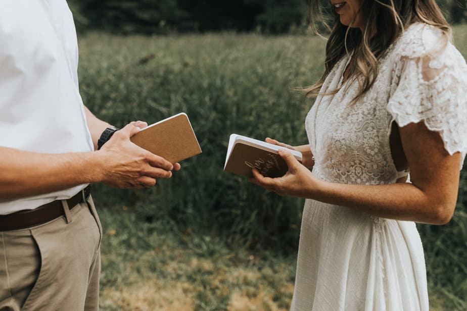 Bride and groom read from vow books during their ceremony.