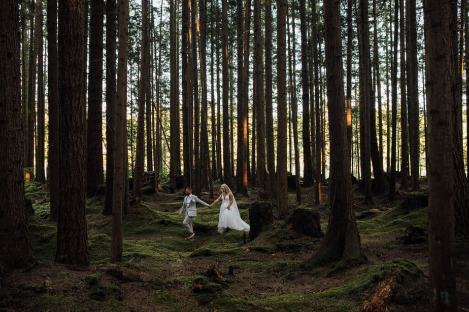 Bride and groom walking through the forest in Washington state