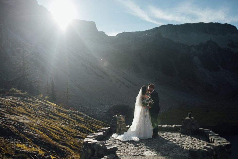 Bride and groom pose on their wedding day in the Olympic Mountains of Washington state.