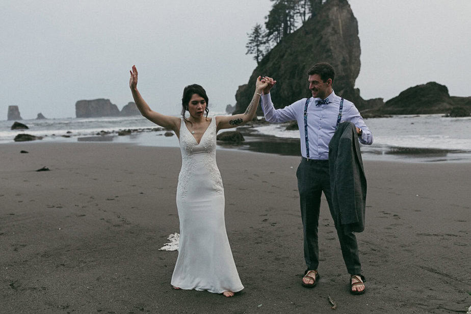 Bride and groom jump for joy at the end of their elopement day at Second Beach in La Push, Washington.