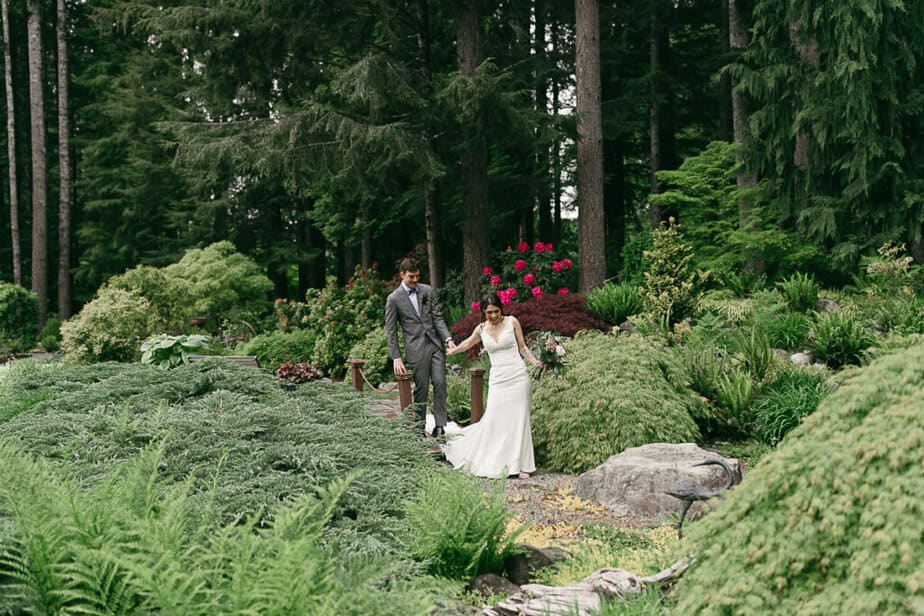 This Fern Acres wedding couple is walking along in the gardens in Forks, WA.