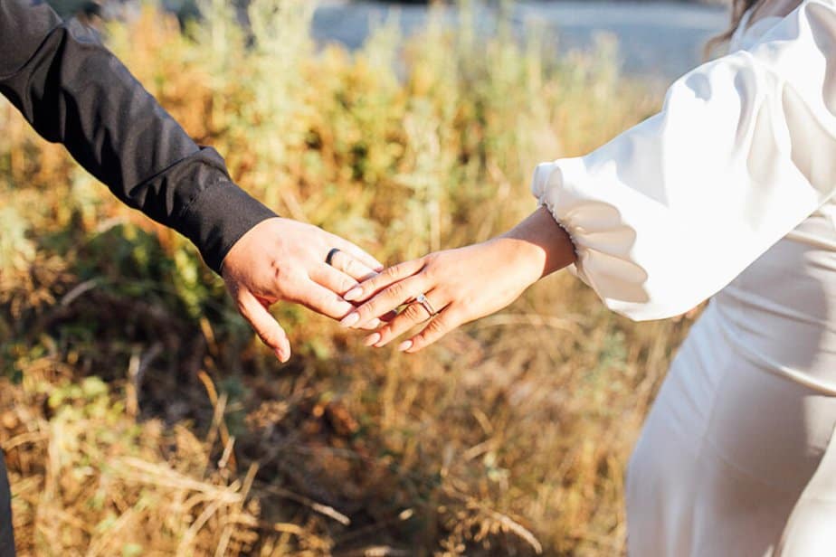 Bride and groom hold hands during their elopement ceremony in Hoh Rainforest.