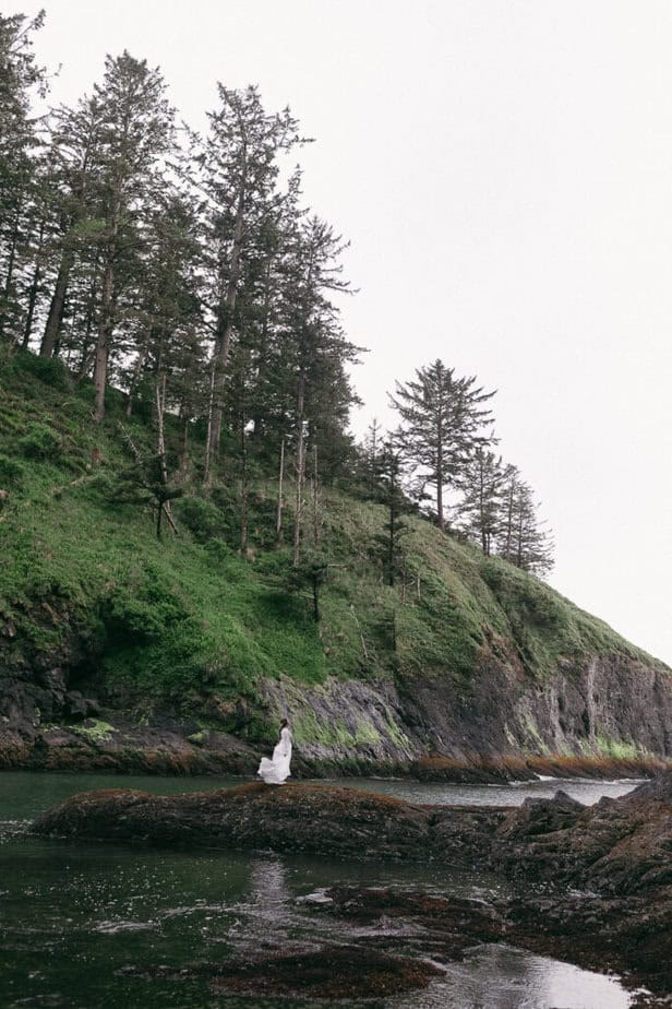 A bride poses for portraits during her elopement along the Oregon coast. 