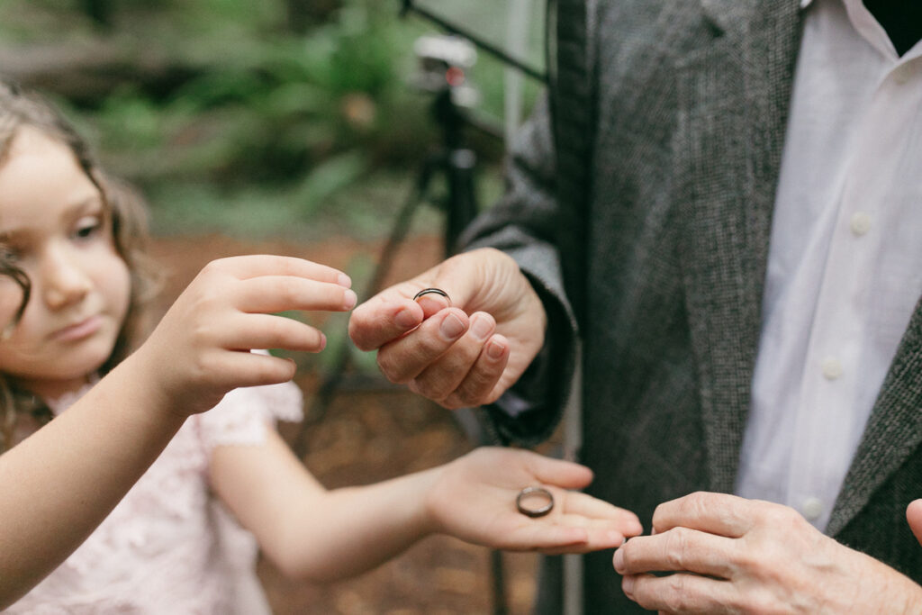 An eloping couple share rings during their ceremony in the redwoods. 