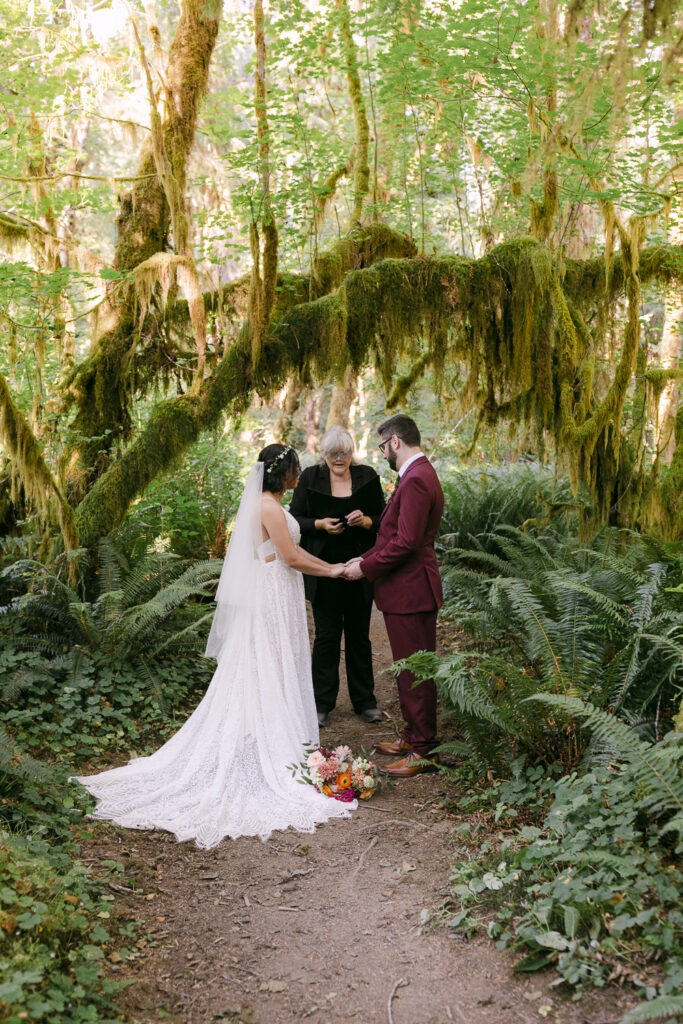 Bride and groom during their ceremony in the forests of Olympic National Park.