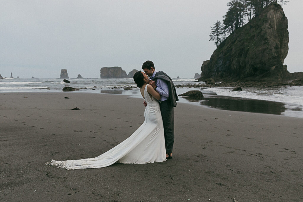 Bride and groom share a first kiss during their elopement on Second Beach in Forks, Washington.